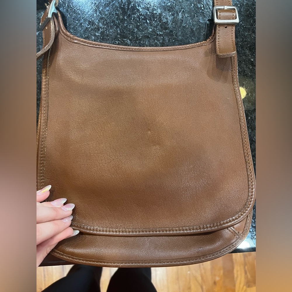 A vintage coach genuine leather Crossbody purse.